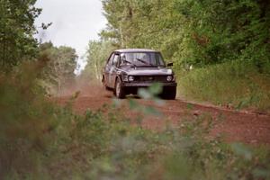 The Jerry Sweet / Stuart Spark SAAB 99EMS comes over a crest on Indian Creek Trail Rd.