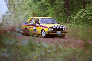 The John Golden / Al Kintigh Datsun 510 comes over a crest on Indian Creek Trail Rd.