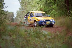 The David Ralakis / Tom Gillespie Mazda 323GTX comes over a crest and into the spectator location in the Two Inlets SF.