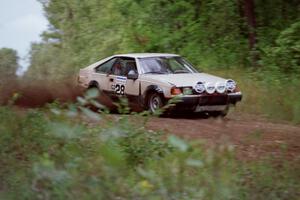 Dave Konetski / Glenn Koehler come flying over a crest and kick up a huge spray of gravel in their Toyota Celica.