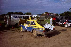 Sam Bryan / Rob Walden get their Saab 900 serviced in Park Rapids on day two of the rally.