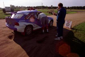 Dave Fuss and Mark Larson chat with Carl Merrill / John Bellefleur in their Ford Escort Cosworth before they leave Park Rapids.