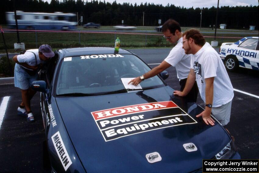 Jim Anderson goes over notes with Ben Greisler at their Honda Prelude VTEC during parc expose.