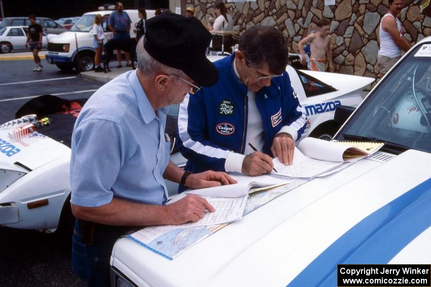 Ken Stewart goes over notes with a crew member(?) on the hood of the Chevy S-10 he and Doc Shrader shared.