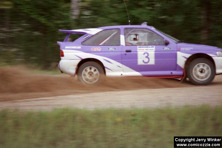 Carl Merrill / John Bellefleur accelerate from the county road spectator point in their Ford Escort Cosworth.