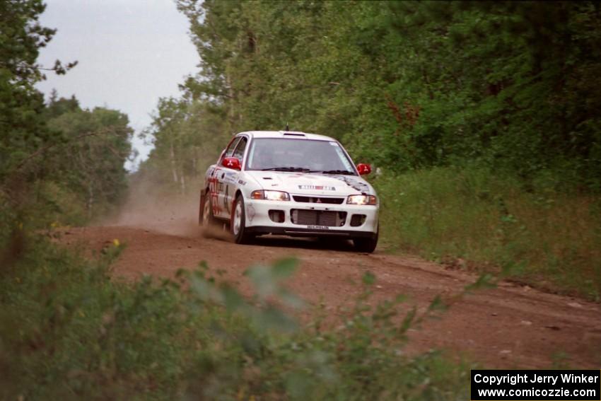 Henry Joy IV / Chris Griffin in their Mitsubishi Lancer Evo II come into the spectator location at the county road.