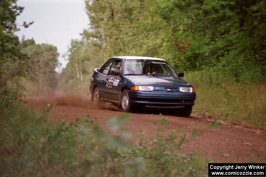 The Tad Ohtake / Bob Martin Ford Escort GT at speed down Indian Creek Trail Rd. on day two.