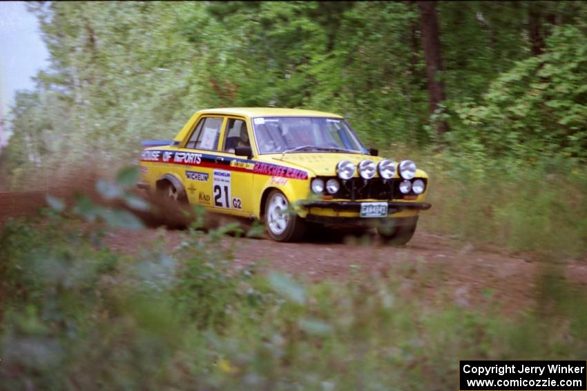 The John Golden / Al Kintigh Datsun 510 comes over a crest on Indian Creek Trail Rd.