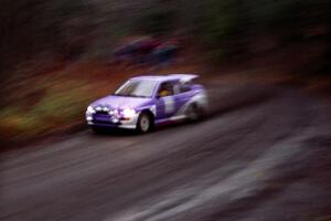 The Carl Merrill / John Bellefleur Ford Escort Coswort RS rockets away from the start just after the rain began.