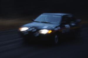 Tad Ohtake / Bob Martin start off SS1 during a heavy rain storm in their Ford Escort GT.