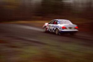 Paul Choinere / Jeff Becker Hyundai Elantra at speed in the rain near the start of SS1.