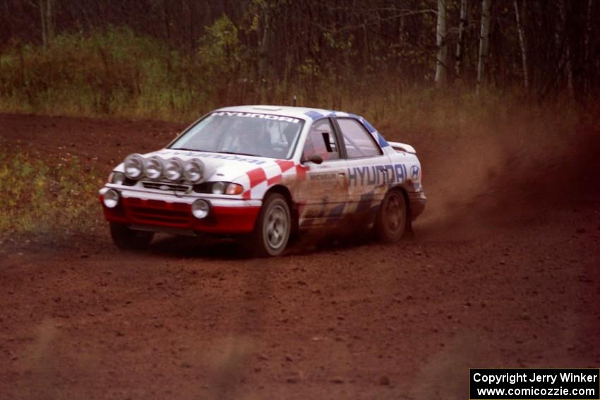 The Paul Choinere / Jeff Becker Hyundai Elantra sling gravel while in a perfect drift on the practice stage.
