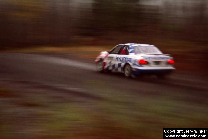 Paul Choinere / Jeff Becker Hyundai Elantra at speed in the rain near the start of SS1.