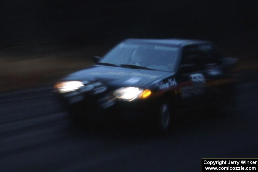 Tad Ohtake / Bob Martin start off SS1 during a heavy rain storm in their Ford Escort GT.