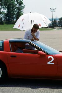 Bill Hoxmeier seated in his S Stock Chevy Corvette chats with Mark Baker at the start