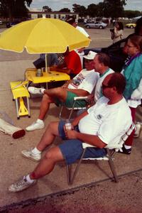 Mark Utecht, ??? and Don Gettinger watch the action from folding chairs at the timing stand