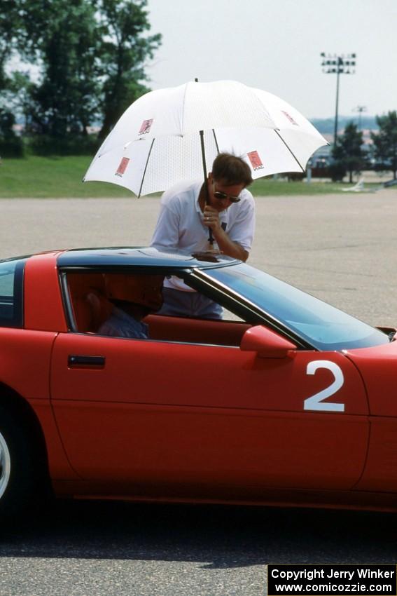 Bill Hoxmeier seated in his S Stock Chevy Corvette chats with Mark Baker at the start