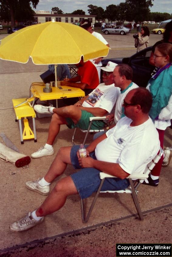 Mark Utecht, ??? and Don Gettinger watch the action from folding chairs at the timing stand