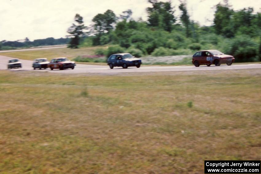 Improved Touring and Showroom Stock cars stream into corner 7.