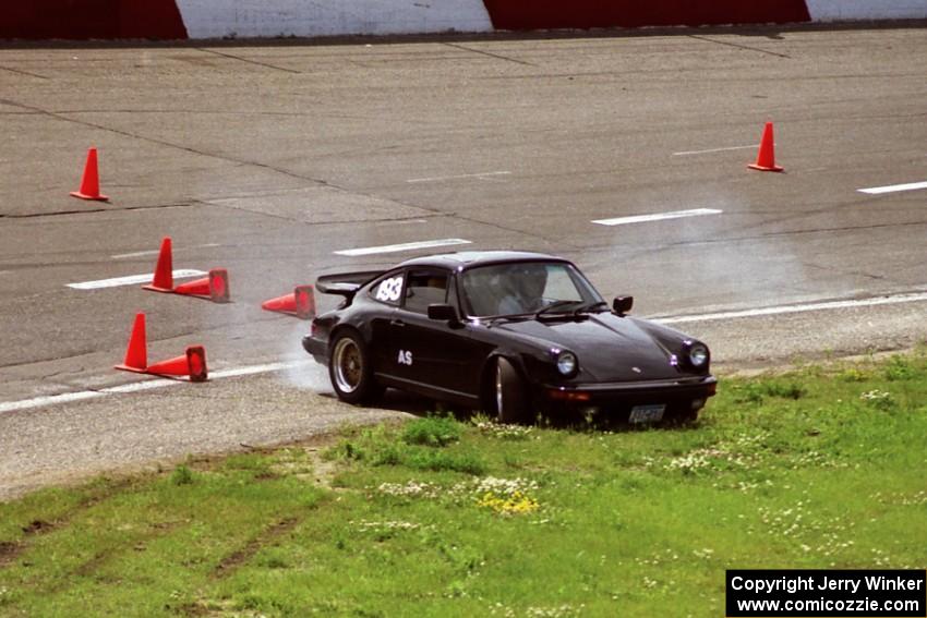 Jeff Lawrence's A Stock Porsche 911 spins to the infield