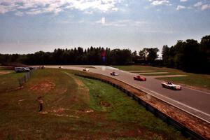 Spec Racer Fords stream out of turn nine toward the bridge