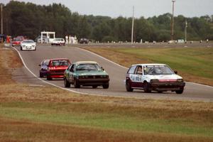 Cars in the Enduro race stream out of turn six into seven.