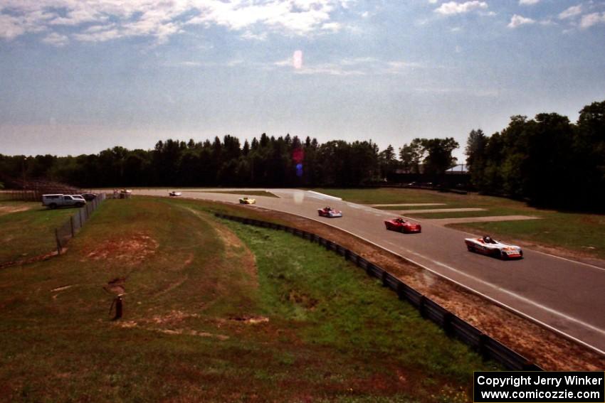 Spec Racer Fords stream out of turn nine toward the bridge