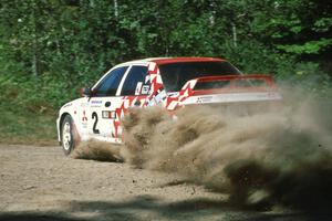 Henry Joy IV / Mike Fennell blast their Mitsubishi Lancer Evo II through the sweeper at the crossroads.