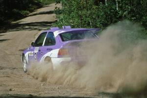 Carl Merrill / John Bellefleur blast uphill out of a fast right at the crossroads in their Ford Escort Cosworth.