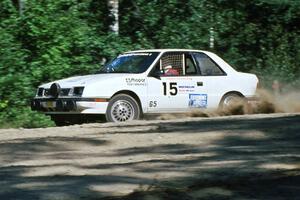 The Henry Krolikowski / Cindy Krolikowski Dodge Shadow drifts through the uphill sweeper at the crossroads.