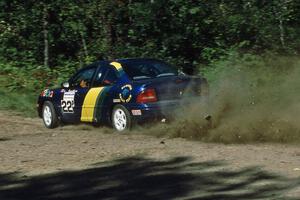 Al Kaumeheiwa / Craig Sobczak drift their Dodge Neon through an uphill sweeper at the crossroads.