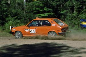 Jason Lajon / John Adleman fly though a sweeper at the crossroads in their Dodge Omni GLH.