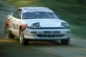 Bruce Newey / Matt Chester at speed in their Toyota Celica Turbo down Parkway Forest Road just before sunset.