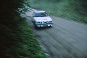 The Henry Krolikowski / Cindy Krolikowski Dodge Shadow flies at speed down Parkway Forest Road just before sunset.