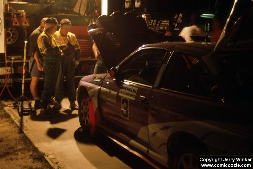 The Carl Merrill / John Bellefleur Ford Escort Cosworth gets serviced on the first night of the rally.