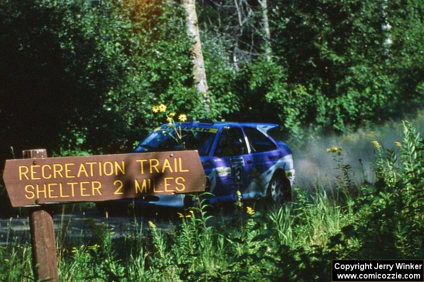 Carl Merrill / John Bellefleur prepare for a fast right at the crossroads in their Ford Escort Cosworth.