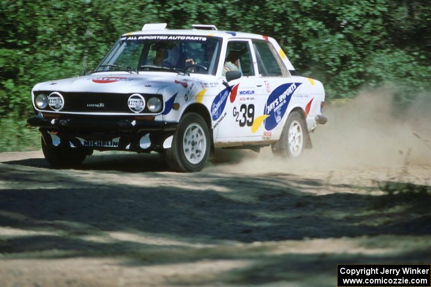 Mike Whitman / Paula Gibeault set their Datsun 510 up for a fast sweeper at the crossroads.