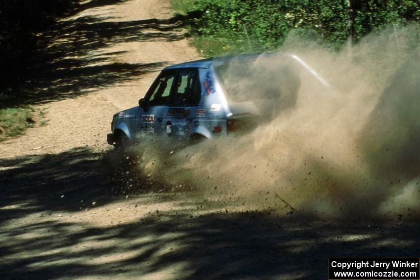 Jason Anderson / Jared Kemp drift wide at the crossroads in their Dodge Omni.