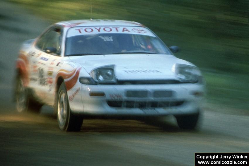 Bruce Newey / Matt Chester at speed in their Toyota Celica Turbo down Parkway Forest Road just before sunset.
