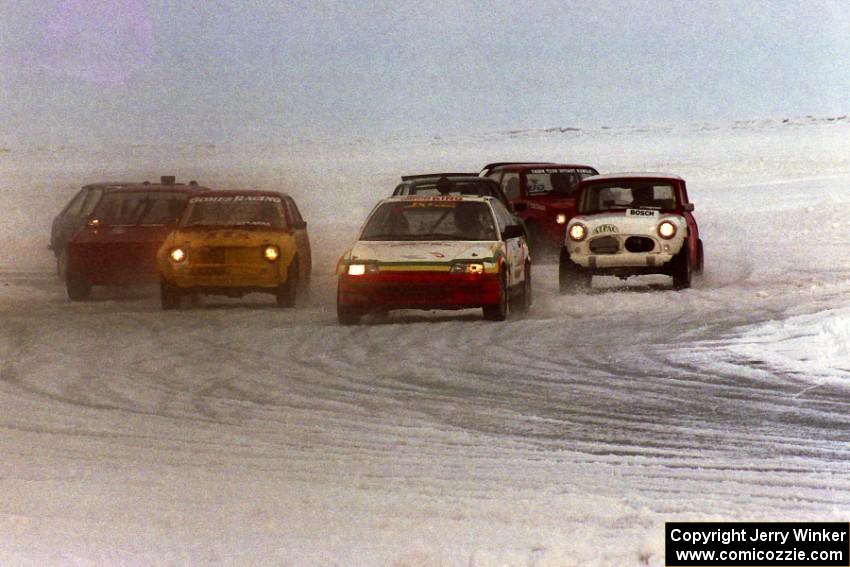 Non-studded race: The field comes out of turn one on the first lap. Paolo Gomez leads in his Honda CRX.