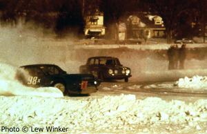 John Jones's SAAB Sonett III goes wide into corner one after passing George McLaughlin's Renault R-8 Gordini.