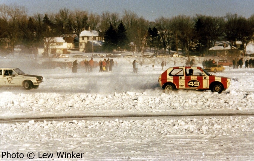 Tom Jones' VW Rabbit accelerates out of corner one after passing Tim Winker's Datsun 510.