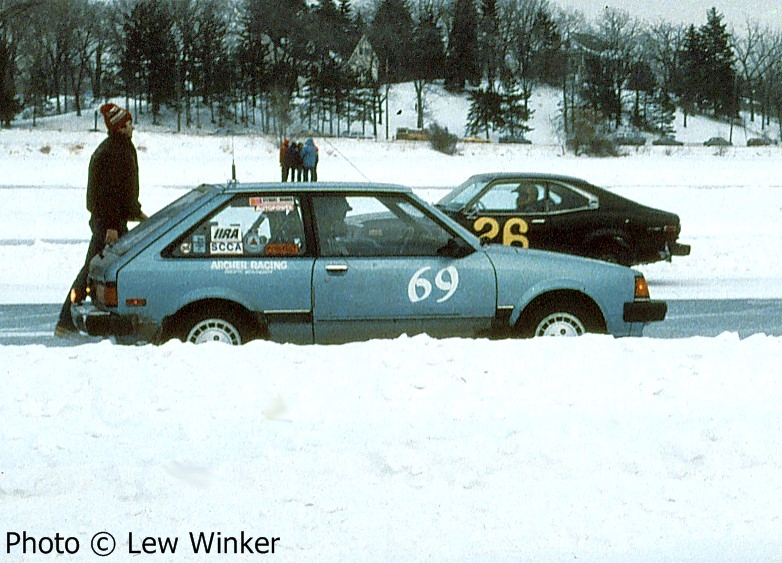 Tim Winker / Jeff Ruzich Mazda GLC on the grid. The Don and Marianne Coatsworth Mazda RX-3 is in the background.