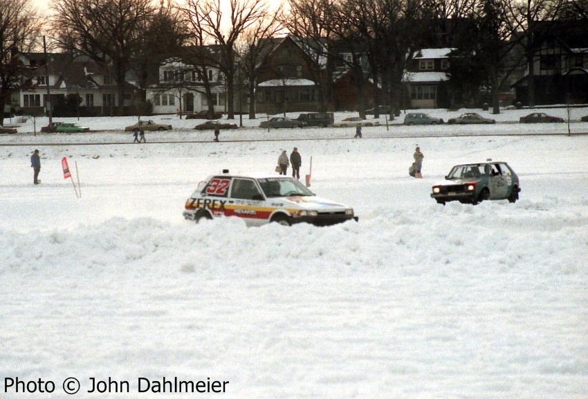 Larry Menard, Jr./ Larry Menard, Sr. Toyota FX-16 leads the Dick Nordby / Wally Rennick VW Rabbit through corner two.