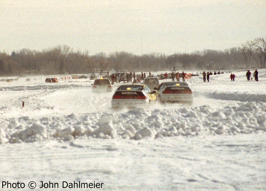 Heading toward the main straight, the factory Hondas are about to pass several cars.