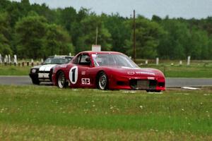 Doug Sherwood's GT-3 Mazda RX-7 and Harvey West's American Sedan Ford Mustang LX