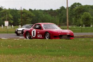 Doug Sherwood's GT-3 Mazda RX-7 and Harvey West's American Sedan Ford Mustang LX