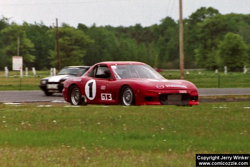 Doug Sherwood's GT-3 Mazda RX-7 and Harvey West's American Sedan Ford Mustang LX