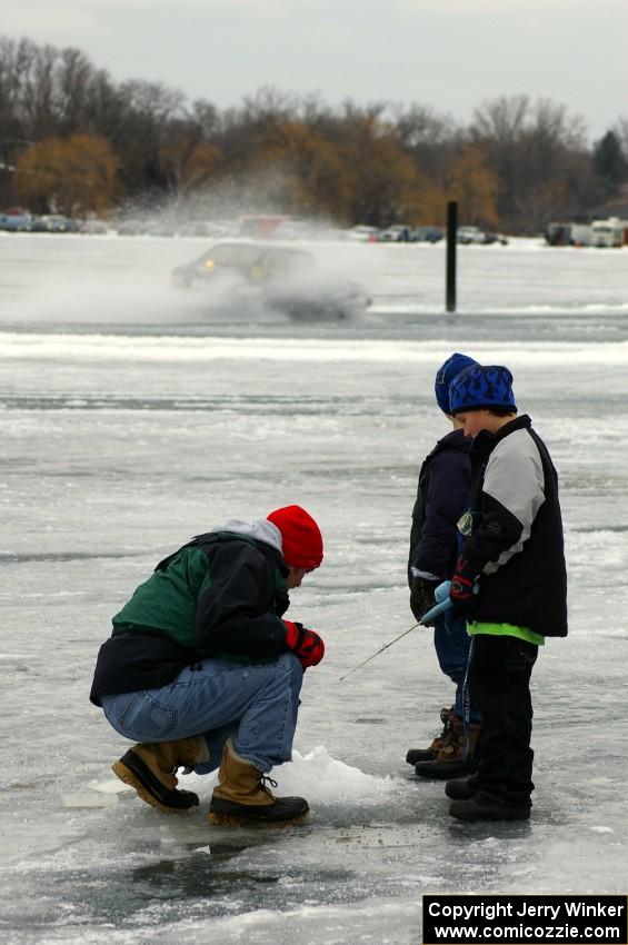 Dan Burhans, Sr. / Dan Burhans II SAAB 900 passes by some folks out ice fishing