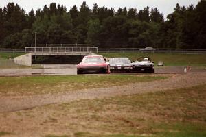 Doug Sherwood's GT-3 Mazda RX-7, Jim Courtney's GT-1 Olds Cutlass Supreme and Mike Froh's E Production MGB into turn 10